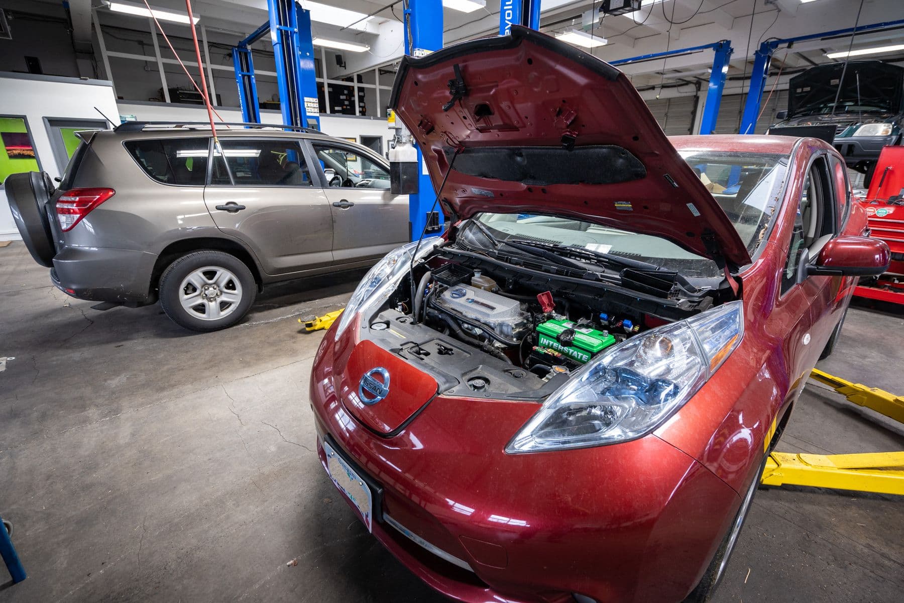 A Nissan Leaf in the shop at Atomic Auto