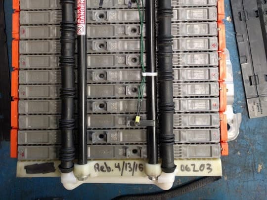 A hybrid battery pack opened on the bench at Atomic Auto